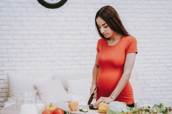 pregnant woman making a meal