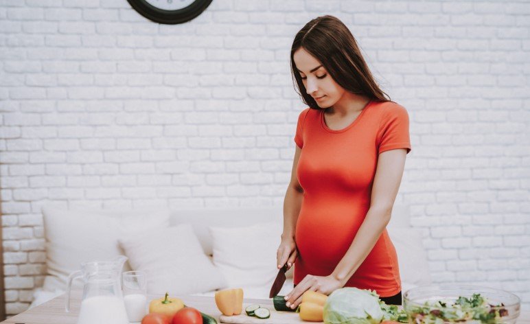 pregnant woman making a meal